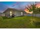 Backyard with green grass and a privacy fence at sunset at 7068 Lanier Falls Rd, Deland, FL 32724
