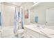 Bright bathroom with a shower-tub combo, vanity with white countertop, and a large mirror at 7068 Lanier Falls Rd, Deland, FL 32724