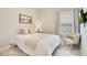 Comfortable bedroom featuring a cozy bed, a window, and a decorative chair at 7068 Lanier Falls Rd, Deland, FL 32724