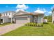 Charming single-story home featuring a two-car garage and nicely manicured landscaping at 7068 Lanier Falls Rd, Deland, FL 32724