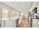 Bright kitchen features stainless appliances, white cabinets, and a large center island with sink at 7068 Lanier Falls Rd, Deland, FL 32724
