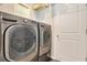 Convenient laundry room featuring a side-by-side washer and dryer and plenty of storage space at 7068 Lanier Falls Rd, Deland, FL 32724