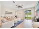 Bright living room with luxury vinyl plank flooring and sliding glass doors at 7068 Lanier Falls Rd, Deland, FL 32724