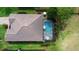 Aerial view showcasing a well-maintained home with a tiled roof, screened-in pool, and landscaped yard at 716 Riviera Bella Dr, Debary, FL 32713