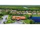Stunning aerial view of a community with lush greenery, a pool, and lovely homes near a serene river at 716 Riviera Bella Dr, Debary, FL 32713
