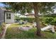 Backyard features a seating area with umbrella, fire pit, lush greenery, and a view of the house at 716 Riviera Bella Dr, Debary, FL 32713