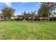 Large backyard showcasing lush greenery, mature trees, playground, and a screened-in pool area at 716 Riviera Bella Dr, Debary, FL 32713