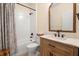 Well-lit bathroom with a shower-tub combination, a wooden vanity with a marble countertop at 716 Riviera Bella Dr, Debary, FL 32713