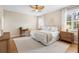 A bright bedroom with neutral tones, wood floors, a ceiling fan, and plantation shutters on the windows at 716 Riviera Bella Dr, Debary, FL 32713