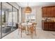 Cozy dining area with a round table, wicker pendant light, and access to the outdoor patio at 716 Riviera Bella Dr, Debary, FL 32713