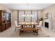 Elegant dining room featuring a long table, a fireplace, and a built-in cabinet at 716 Riviera Bella Dr, Debary, FL 32713