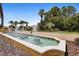 Exterior of a community entrance featuring a decorative fountain with palm trees and landscaping at 716 Riviera Bella Dr, Debary, FL 32713