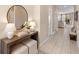 Inviting foyer with modern console table, round mirror, and neutral color palette at 716 Riviera Bella Dr, Debary, FL 32713