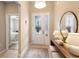 Bright foyer featuring a decorative front door, console table, and a view into the bedroom at 716 Riviera Bella Dr, Debary, FL 32713