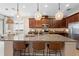 Spacious kitchen featuring a large island with seating and modern pendant lighting at 716 Riviera Bella Dr, Debary, FL 32713