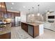 Well-appointed kitchen with granite counters, stainless steel appliances, and open floor plan at 716 Riviera Bella Dr, Debary, FL 32713