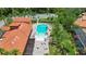 Aerial view of a community pool featuring a unique shape, lounge chairs and plenty of beautiful palm trees at 716 Riviera Bella Dr, Debary, FL 32713