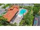 Aerial view showcases a large community pool, surrounded by lush landscaping and patio furniture, perfect for relaxation at 716 Riviera Bella Dr, Debary, FL 32713