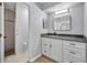 Modern bathroom featuring a granite countertop, white cabinets, and a walk-in shower at 717 S Ridgewood Ave, Ormond Beach, FL 32174