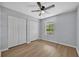 Cozy bedroom featuring light grey walls, wood floors, and a modern ceiling fan at 717 S Ridgewood Ave, Ormond Beach, FL 32174
