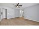 Large bedroom featuring wood floors, ceiling fan and access to the bathroom at 717 S Ridgewood Ave, Ormond Beach, FL 32174