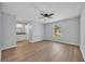 Spacious bedroom with wood floors, a ceiling fan, and an attached bathroom at 717 S Ridgewood Ave, Ormond Beach, FL 32174