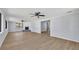 Open living room featuring wood floors, a fireplace, and multiple ceiling fans at 717 S Ridgewood Ave, Ormond Beach, FL 32174