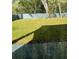 Backyard with a well-maintained lawn, a privacy fence, and mature trees at 736 S Stone St, Deland, FL 32720