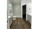 Modern bathroom features a walk-in shower, wood-look flooring, and a neutral color palette at 736 S Stone St, Deland, FL 32720