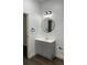 Bathroom featuring vanity with gray cabinet, white countertop, and round mirror at 736 S Stone St, Deland, FL 32720