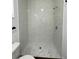 Bathroom showcasing the walk-in shower with white marble style tile at 736 S Stone St, Deland, FL 32720