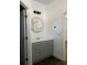 Bathroom featuring vanity with gray cabinet, white countertop, and round mirror at 736 S Stone St, Deland, FL 32720