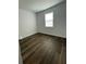 Bright bedroom with wood-look floors and a large window providing natural light at 736 S Stone St, Deland, FL 32720
