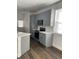 Modern kitchen with gray cabinetry, stainless steel appliances, and quartz countertops at 736 S Stone St, Deland, FL 32720