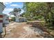 Expansive backyard view showcasing the house, shed, mature trees, and abundant space for various activities at 742 S Martin Luther King Blvd, Daytona Beach, FL 32114