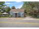 Charming home behind a chain-link fence, featuring light blue siding and brown trim, next to a yellow street at 742 S Martin Luther King Blvd, Daytona Beach, FL 32114