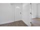 Bright hallway with laminate flooring and a white door at 742 S Martin Luther King Blvd, Daytona Beach, FL 32114