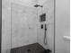 Contemporary shower design featuring white marbled tile, black fixtures, and a shower niche for storage at 742 S Martin Luther King Blvd, Daytona Beach, FL 32114