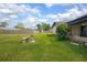 A serene backyard with a well-maintained lawn, small patio, and secured fencing, perfect for outdoor relaxation at 792 Bennett Rd, South Daytona, FL 32119