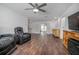 Spacious living room features a ceiling fan, hardwood floors and entertainment center at 792 Bennett Rd, South Daytona, FL 32119