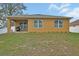 View of the backyard featuring the exterior elevation, lawn and covered patio at 859 Oak Hollow Loop, Deland, FL 32724