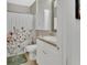 Cozy bathroom with a floral shower curtain and a white vanity with granite counters at 859 Oak Hollow Loop, Deland, FL 32724
