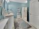 Bathroom featuring double sink vanity, shower with curtain, turquoise walls, and ceramic tile flooring at 859 Oak Hollow Loop, Deland, FL 32724