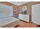 Bedroom with hardwood floors, white dresser, tv, and a decorative white headboard on the bed at 859 Oak Hollow Loop, Deland, FL 32724