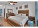 Comfortable bedroom featuring a wood-framed bed, light colored walls, and hardwood flooring at 859 Oak Hollow Loop, Deland, FL 32724
