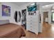 Bedroom with a white dresser, wall-mounted television and access to a walk-in closet at 859 Oak Hollow Loop, Deland, FL 32724