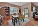 Inviting dining area with wooden table, comfortable chairs, and a sliding glass door to an outdoor space at 859 Oak Hollow Loop, Deland, FL 32724