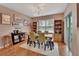 Cozy dining room with a wooden table, comfortable seating, and natural light, perfect for Gathering meals at 859 Oak Hollow Loop, Deland, FL 32724