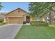 Charming single-story home with a well-manicured lawn, a two car garage, and attractive landscaping at 859 Oak Hollow Loop, Deland, FL 32724