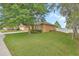 Well-maintained home with a lush green lawn and mature trees providing shade at 859 Oak Hollow Loop, Deland, FL 32724